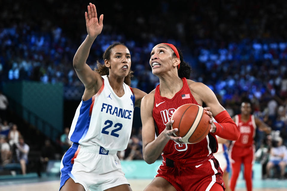 A'ja Wilson drives on France's #22 Marieme Badiane in the Olympic gold medal game. (Aris Messinis / AFP via Getty Images)