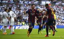 Barcelona's Neymar (R) celebrates with Lionel Messi (C) after scoring against Real Madrid during their Spanish first division "Clasico" soccer match at the Santiago Bernabeu stadium in Madrid October 25, 2014. REUTERS/Sergio Perez (SPAIN - Tags: SOCCER SPORT)
