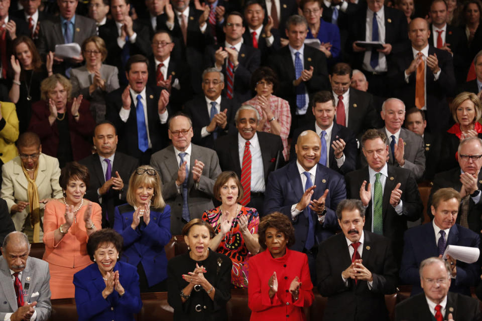 Democratic members of Congress rise and applaud 