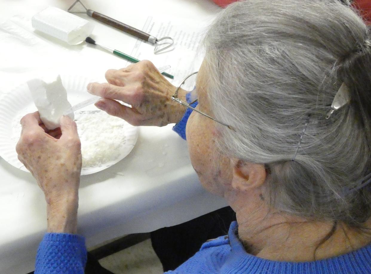 Marilyn Smith carves a bar of soap into a cat figurine during a program on Wednesday afternoon at the Crawford County Council on Aging.