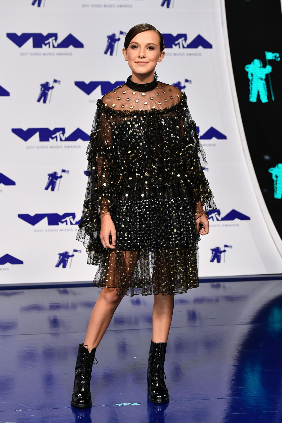 <p>Die Schauspielerin aus ‘Stranger Things’ steht mit ihren 13 Jahren noch nicht lange in der Öffentlichkeit, trotzdem ist sie schon eine kleine Fashionista. Kein Wunder, dass sie für die VMAs mit einer coolen Glitzer-Nummer von Rodarte ausgestattet wurde, zu der Millie keine High Heels sondern schwarze Boots kombinierte. <br>(Foto: Rex Features) </p>