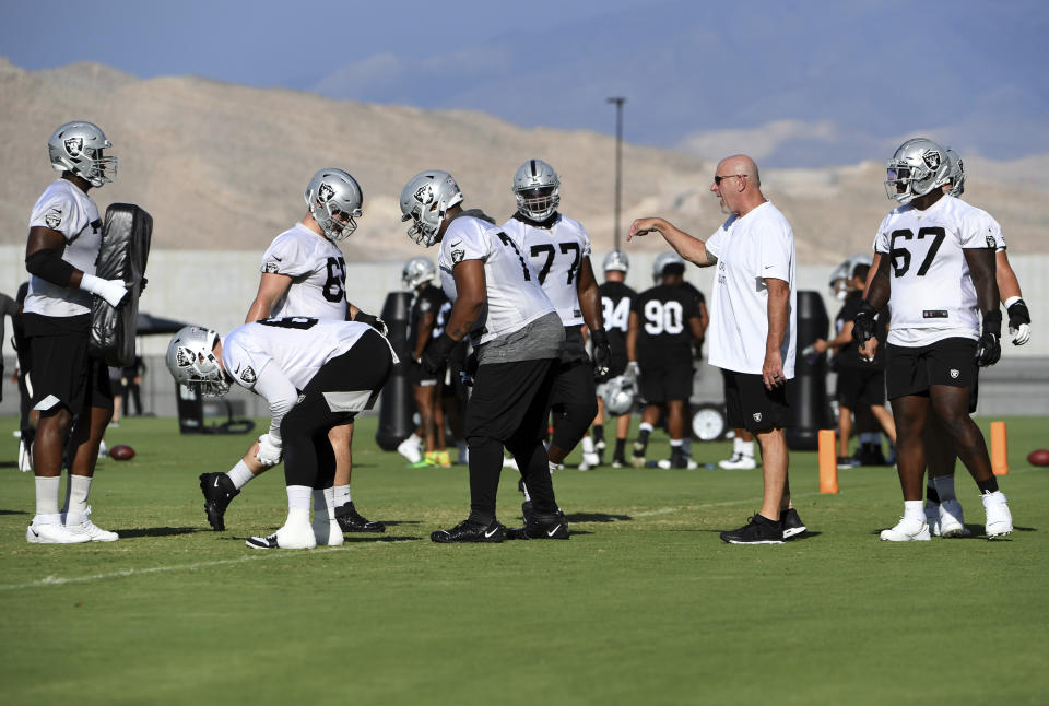 Las Vegas Raiders offensive line coach Tom Cable, second right, directs his players to run drills during an NFL football practice Saturday, July 31, 2021, in Henderson, Nev. (AP Photo/David Becker)