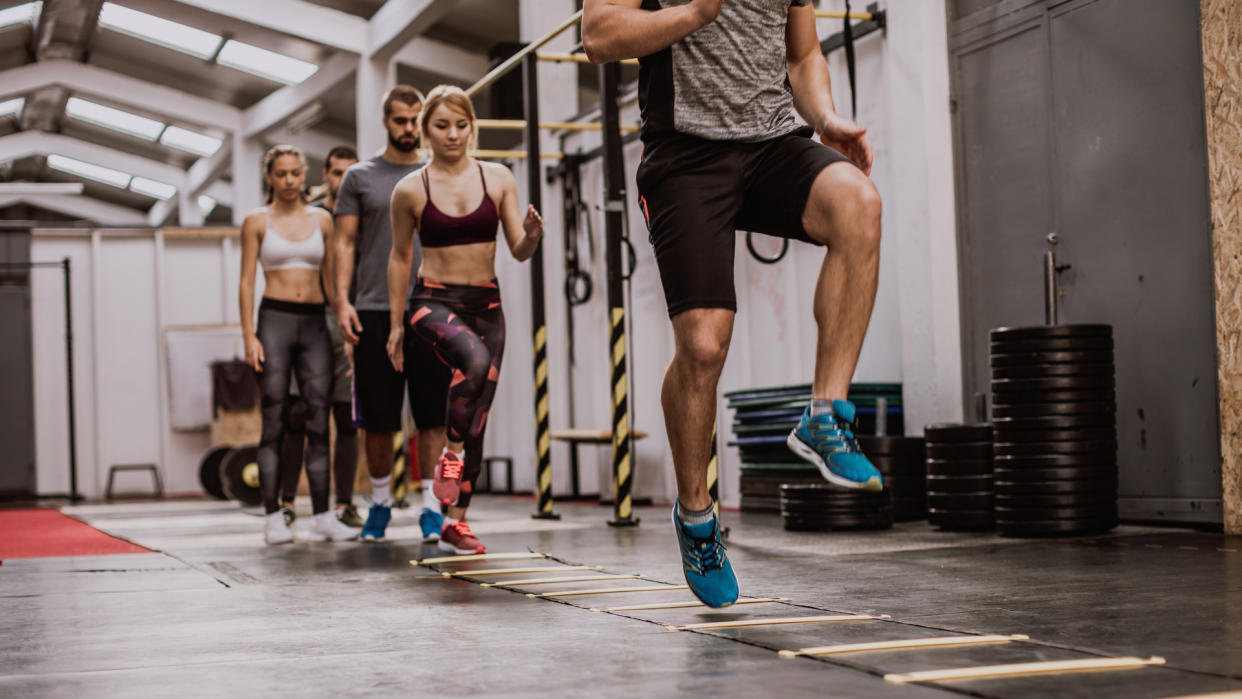 People Doing Warming Up Exercises On Cross Training.