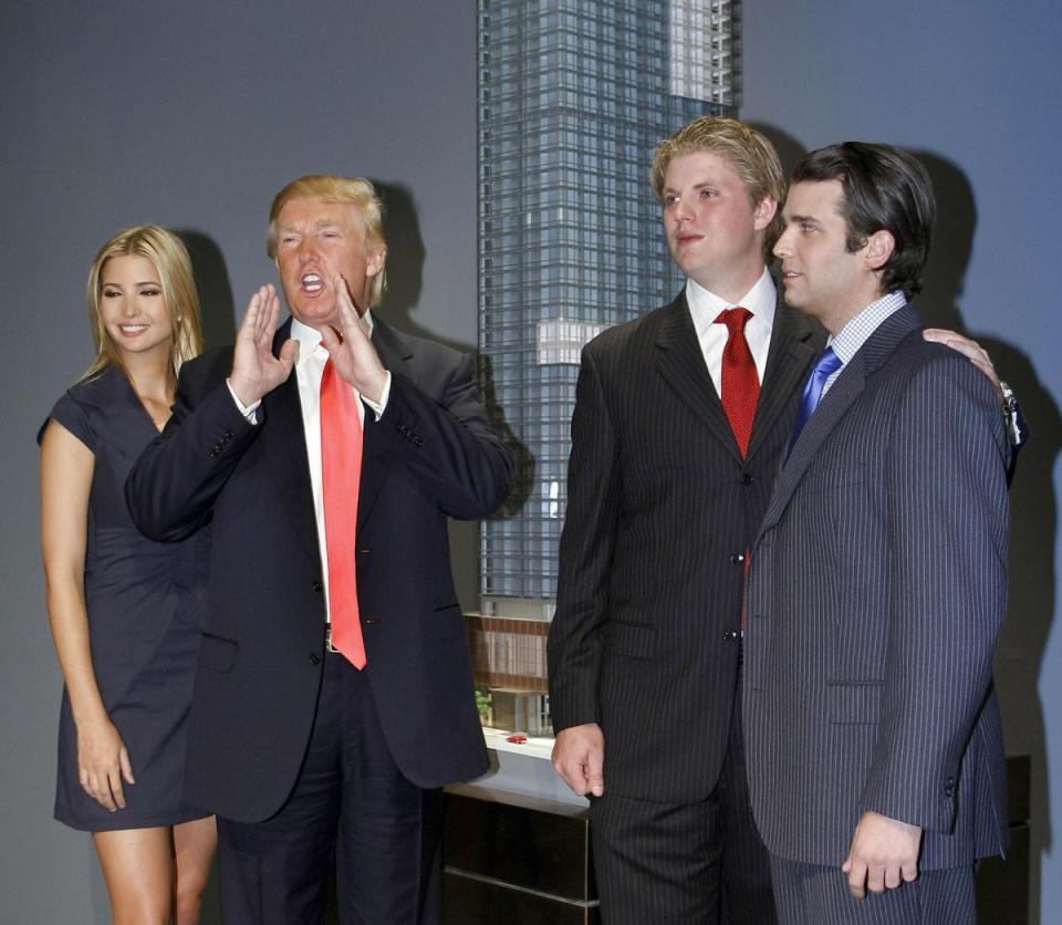 Donald Trump, with his oldest children Ivanka, Eric and Donald Jr, at a press conference announcing the launch of Trump SoHo Hotel Condominium in New York in 2007. The former president, his adult sons and business associates are accused of defrauding banks and insurers by overvaluing properties by billions of dollars (AFP via Getty Images)