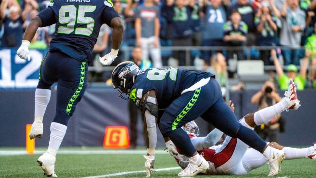 Seattle Seahawks defensive tackle Poona Ford (97) sacks Arizona Cardinals quarterback Kyler Murray (1) during the fourth quarter of an NFL game on Sunday, Oct. 16, 2022, at Lumen Field in Seattle.