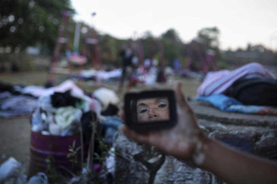 <p>A woman is reflected in a mirror as she gets ready for the day, as Central American migrants traveling with the annual “Stations of the Cross” caravan wake up at a sports club in Matias Romero, Oaxaca State, Mexico, uesday, April 3, 2018. The caravan of Central American migrants that angered U.S. President Donald Trump was sidelined at a sports field in southern Mexico with no means of reaching the border even as Trump tweeted another threat to Mexico Tuesday.(Photo: Felix Marquez/AP) </p>