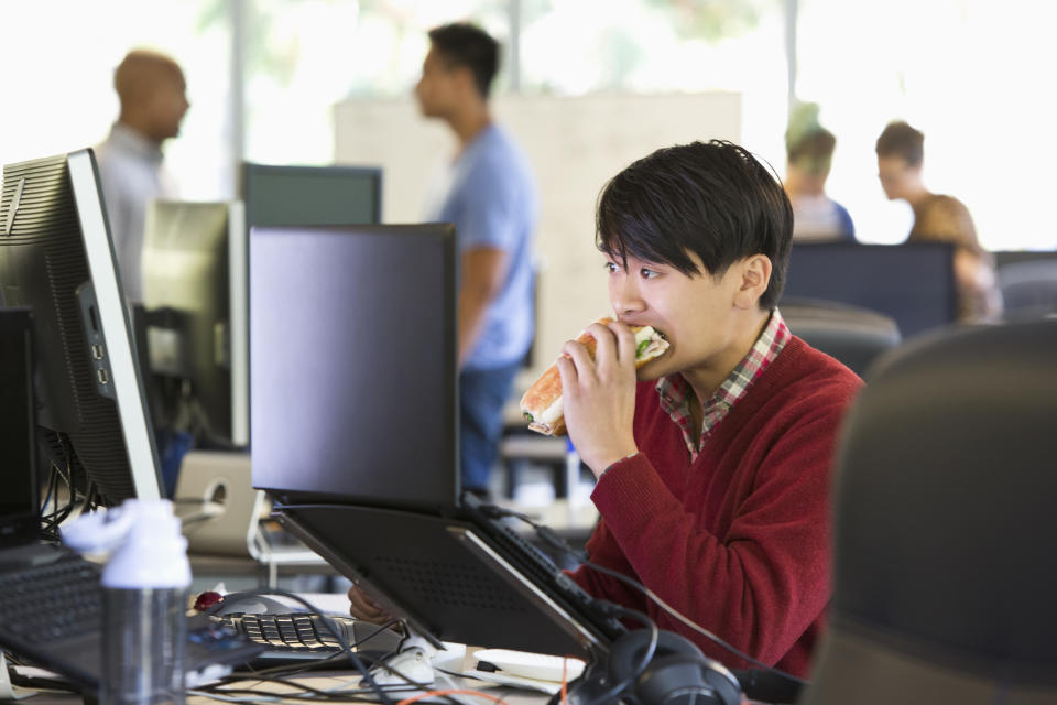 Businessman eating at office desk