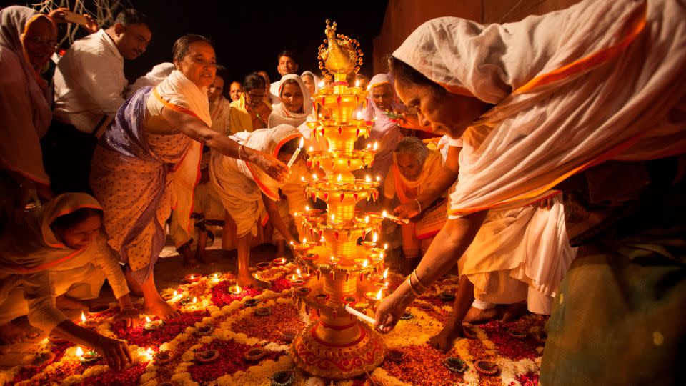 Women light diyas, or earthen lamps, during Diwali celebrations in Vrindavan, India, on October 16, 2017. - Xavier Galiana/AFP/Getty Images