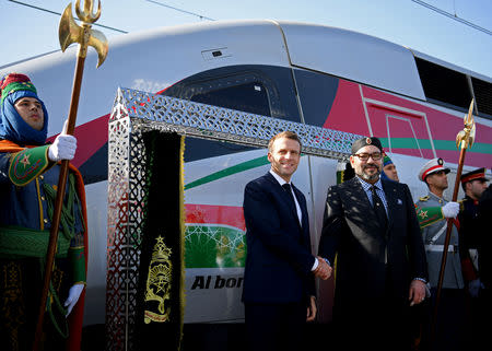 French President Emmanuel Macron and Moroccan King Mohammed VI shake hands as they inaugurate a high-speed line at Rabat train station, in Rabat, France November 15, 2018. Christophe Archambault/Pool via Reuters