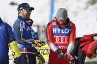 First placed Switzerland's Marco Odermatt, right, celebrates with second placed Norway's Aleksander Aamodt Kilde at the end of an alpine ski, men's World Cup super-G, in Cortina d'Ampezzo, Italy, Saturday, Jan. 28, 2023. (AP Photo/Alessandro Trovati)