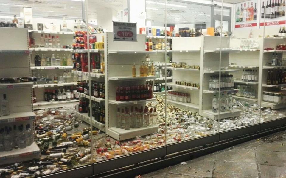 Fallen bottles are seen in a liquor store following an earthquake  - Credit: GIANNIS KIARIS/EPA