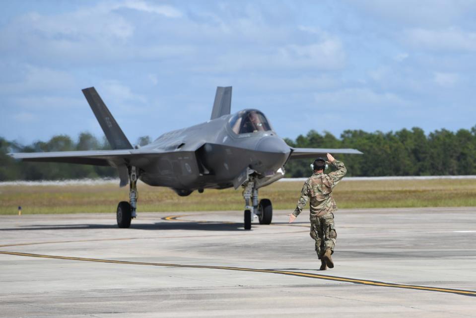 In this 2020 photo, a crew chief guides an F-35 stealth fighter jet in for refueling at Eglin Air Force base. The F-35 is the focus of some of the recent military contracting activity involving bases and businesses in Northwest Florida.