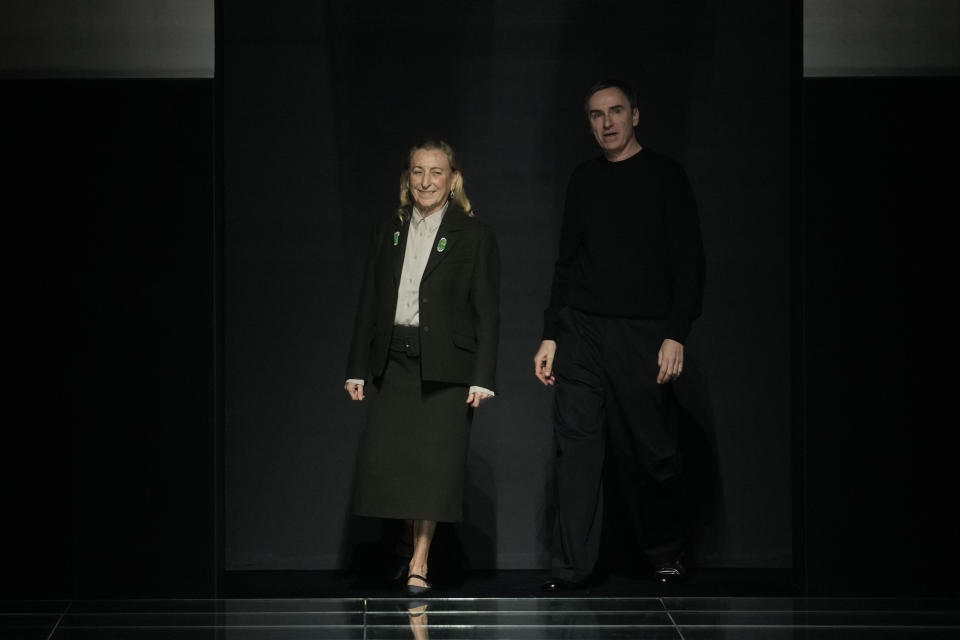 Head designers Miuccia Prada, left, and Raf Simons acknowledge the appluse at the end of the Prada women's Fall-Winter 2024-25 collection presented in Milan, northern Italy, Thursday, Feb. 22, 2024. (AP Photo/Luca Bruno)