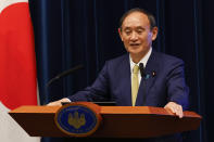 Japan's Prime Minister Yoshihide Suga speaks during a press conference at the prime minister's official residence Tuesday, Sept. 28, 2021, in Tokyo. Suga announced the coronavirus state of emergency will end Thursday so the economy can be reactivated as infections slow. (Rodrigo Reyes Marin/Pool Photo via AP)