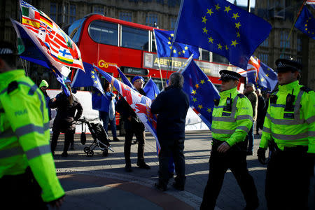 Police officers walk past Anti-Brexit demonstrators outside the Houses of Parliament in London, Britain, January 8, 2019. REUTERS/Henry Nicholls