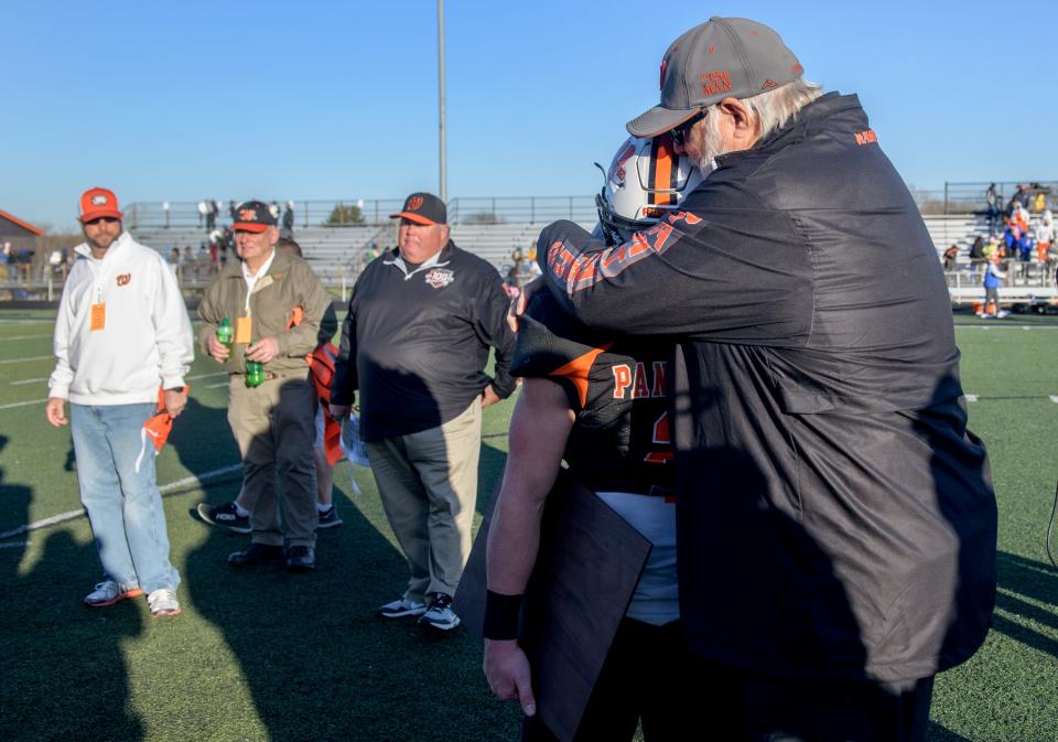 Washington head football coach Darrell Crouch hugs senior running back Kainon McQueary after their 34-18 loss to East St. Louis in the Class 6A football state semifinals Saturday, Nov. 18, 2023 at Babcook Field in Washington.