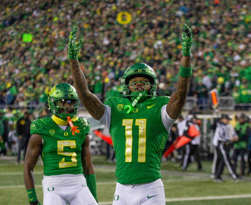 Oregon’s Troy Franklin, right, celebrates his touchdown with fans during the second quarter against Oregon State at Autzen Stadium on Nov. 24.