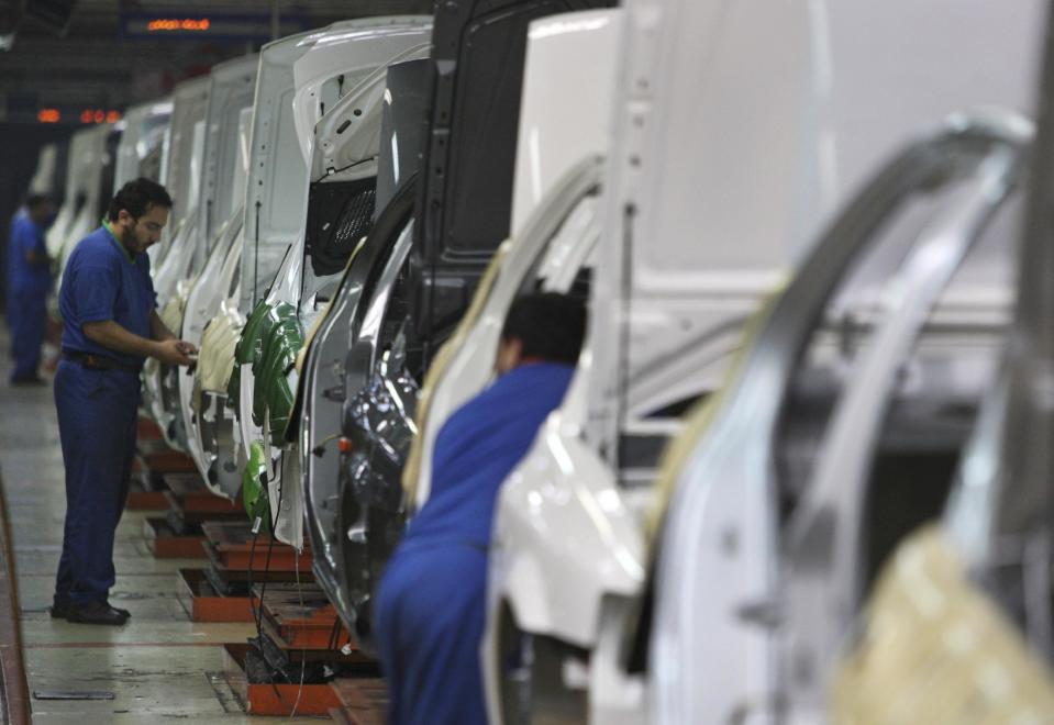 FILE - In this Feb. 7, 2009 file photo, Iranian workers assemble cars at the Iran Khodro automobile manufacturing plant, the biggest car manufacturing company in the Middle East, just outside Tehran, Iran. For many business leaders, Iran is a mouthwatering emerging market, and they could soon find themselves heading to Iran to secure new deals following the suspension of the first international sanctions. (AP Photo/Vahid Salemi, File)