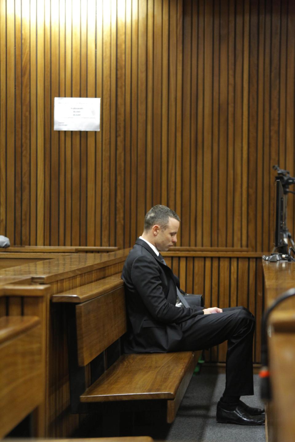 Oscar Pistorius is seated in a courtroom at the high court for his ongoing murder trial in Pretoria, South Africa, Monday, May 12, 2014. Pistorius is charged with the shooting death of his girlfriend Reeva Steenkamp on Valentine's Day in 2013. (AP Photo/Kim Ludbrook, Pool)