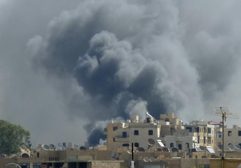 Smoke rises after what activists say was an air strike by forces loyal to Syria's President Assad on Tal Abyad street market in central Raqqa