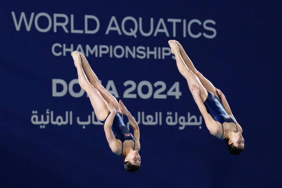 Kim Mi Rae and Jo Jin Mi of North Korea compete during the women's synchronized 10m platform diving final at the World Aquatics Championships in Doha, Qatar, Tuesday, Feb. 6, 2024. (AP Photo/Hassan Ammar)