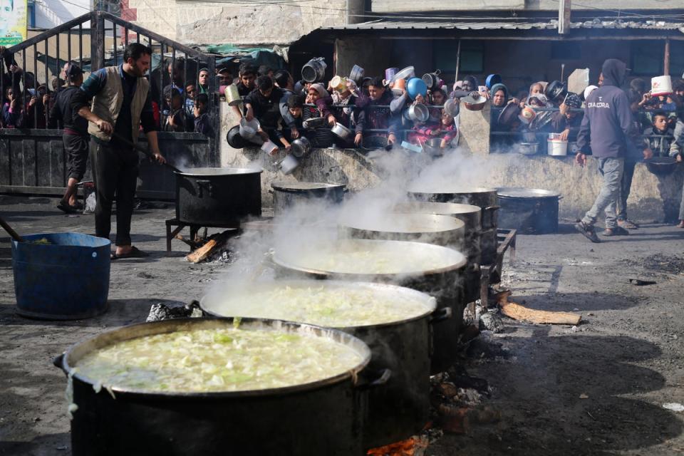 Palestinians line up for free food during the ongoing Israeli air and ground offensive (Copyright 2024 The Associated Press. All rights reserved.)