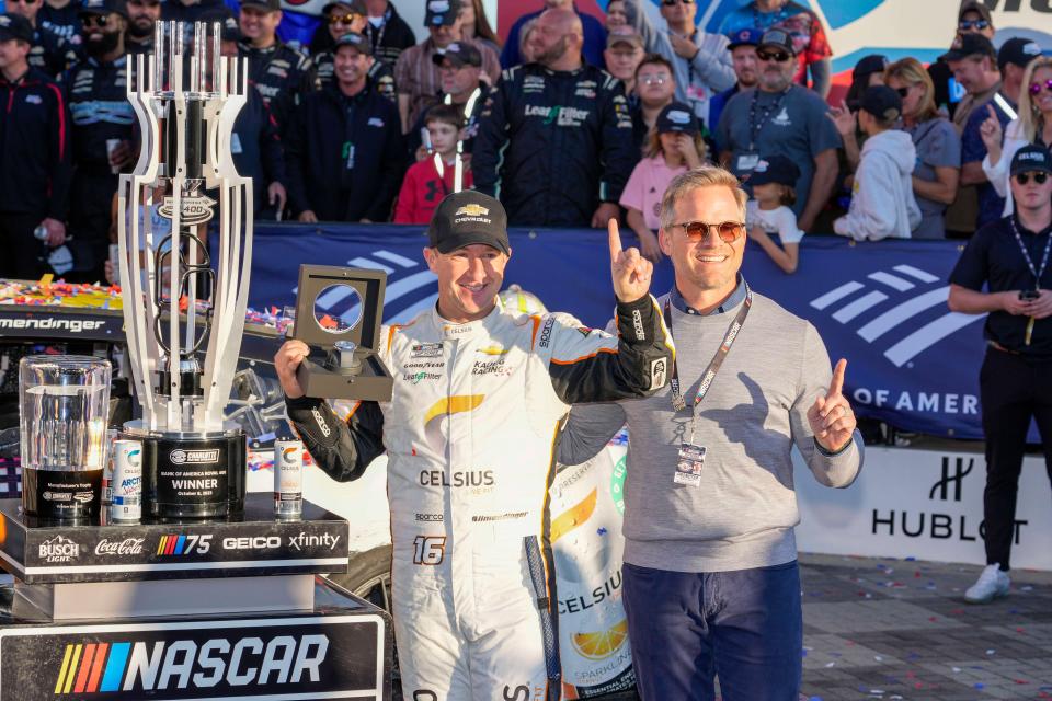 Driver A.J.Allmendinger, left, celebrates with Speedway Motorsports CEO and Charlotte Motor Speedway general manager Marcus Smith, right, after winning Sunday's Bank of America Roval 400.