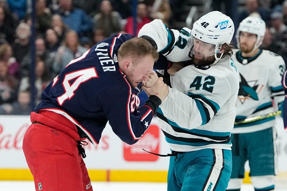 Jan 21, 2023; Columbus, Ohio, USA;  Columbus Blue Jackets right wing Mathieu Olivier (24) fights San Jose Sharks left wing Jonah Gadjovich (42) during the second period of the NHL hockey game at Nationwide Arena. Mandatory Credit: Adam Cairns-The Columbus Dispatch