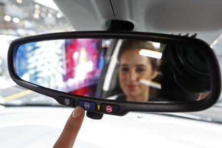 A model switches on the OnStar connectivity system inside an Opel Karl during the second press day ahead of the 85th International Motor Show in Geneva March 4, 2015. REUTERS/Arnd Wiegmann