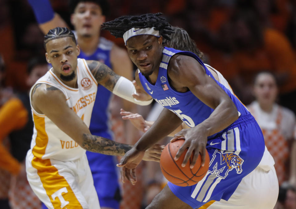 Memphis forward Precious Achiuwa (55) works for a shot as he's defended by Tennessee guard Lamonte Turner (1) during the first half of an NCAA college basketball game Saturday, Dec. 14, 2019, in Knoxville, Tenn. (AP Photo/Wade Payne)