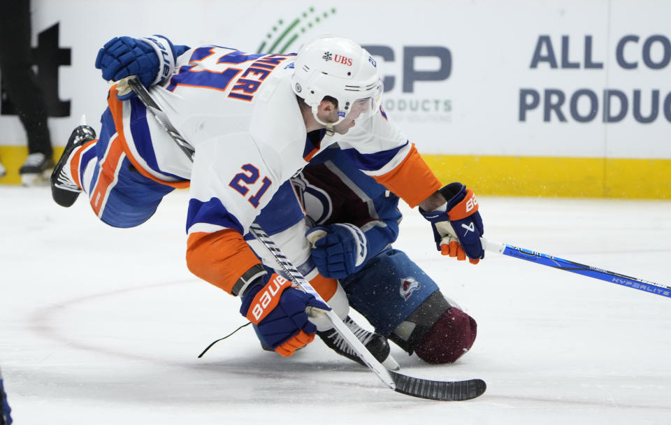 New York Islanders center Kyle Palmieri, left, is pulled down by Colorado Avalanche center Andrew Cogliano during the second period of an NHL hockey game Tuesday, Jan. 2, 2024, in Denver. (AP Photo/David Zalubowski)