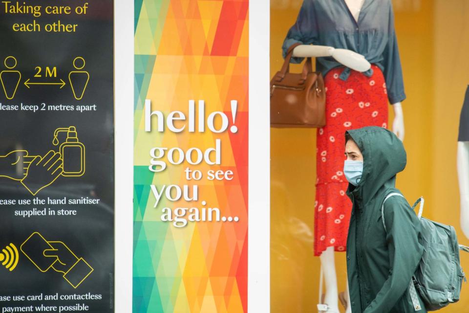 A woman wearing a mask in London (PA)