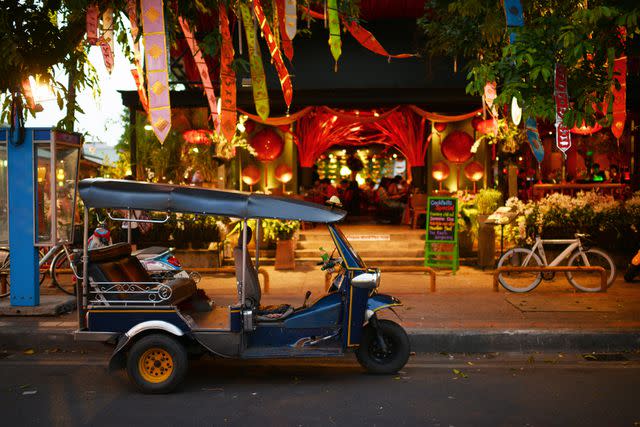 <p>PhotoTalk/Getty Images</p> Tuk tuk parked on the street one peaceful night.