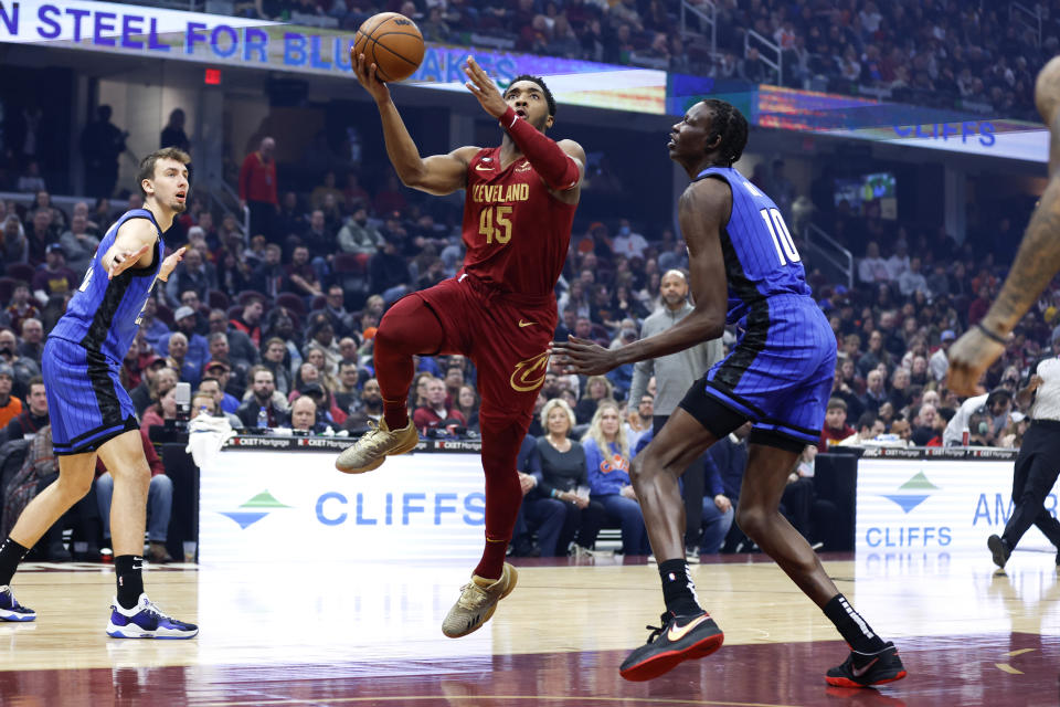 Cleveland Cavaliers guard Donovan Mitchell (45) shoots against Orlando Magic center Bol Bol (10) during the first half of an NBA basketball game, Friday, Dec. 2, 2022, in Cleveland. (AP Photo/Ron Schwane)