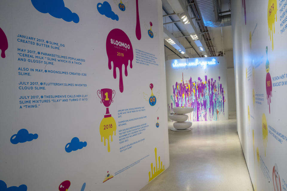 This Oct. 21, 2019, photo shows a timeline of the history of slime during a preview of the Sloomoo Institute in New York. An immersive, 8,000-square-foot museum dedicated to all things slime opens Friday for a nearly six-month celebration before hitting the road to other locales. (AP Photo/Mary Altaffer)