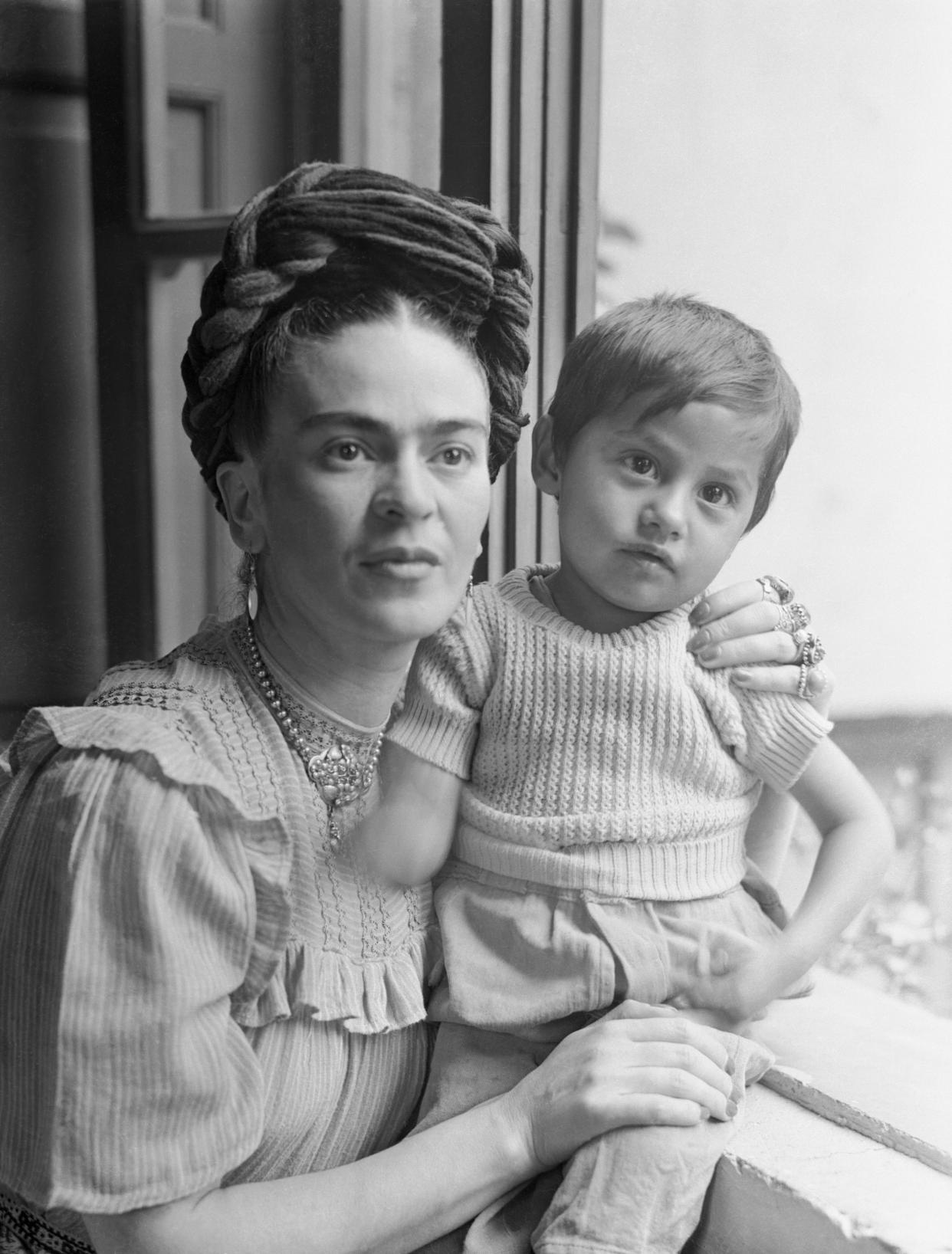 (Original Caption) Frida Kahlo, (1910-1954), Mexican painter and wife of Diego Rivera is shown here with child.