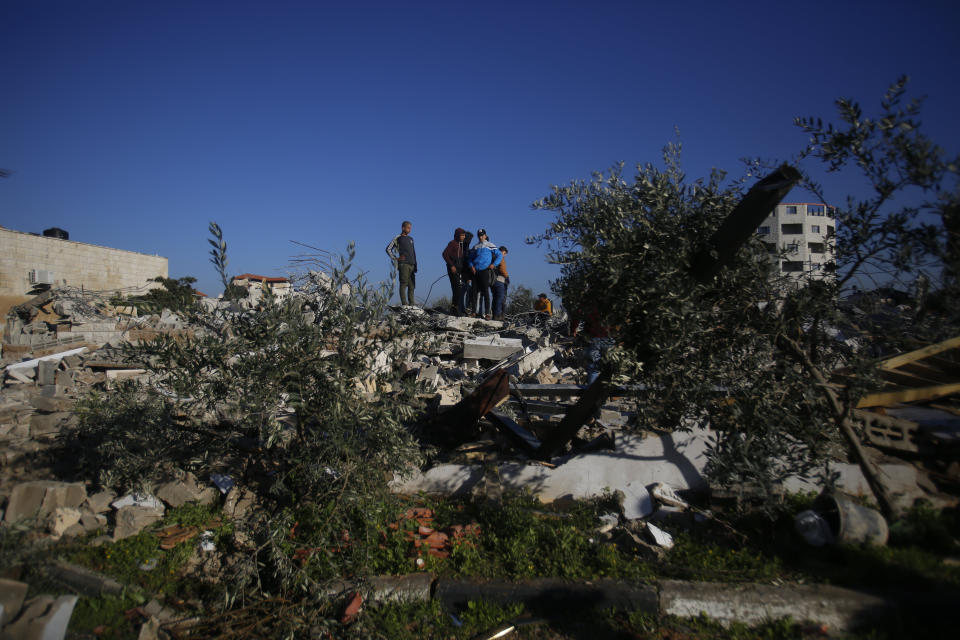 Palestinians inspect a house after it was demolished by the Israeli army in the West Bank city of Jenin, Thursday, Feb. 6, 2020. Israeli military spokesman Lt. Col. Jonathan Conricus said troops were carrying out the demolition of a home belonging to a militant allegedly involved in a deadly attack. (AP Photo/Majdi Mohammed)