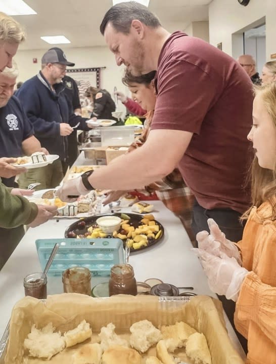 Chad Tucker, family serve Thanksgiving meals to firefighters at Sauratown Mountain