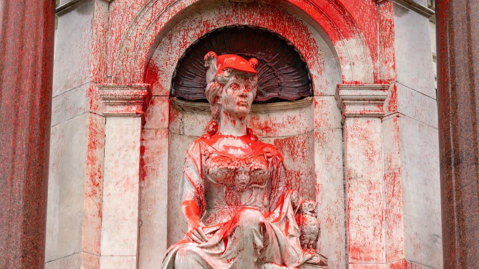 A Queen Victoria monument in Melbourne, Australia, is doused with red paint on January 25, 2024. - Diego Fedele/AAP/AP