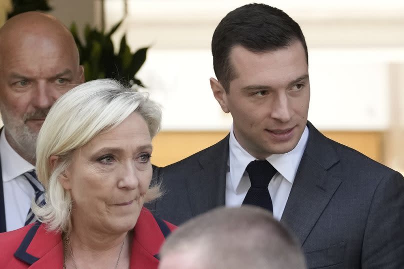 Far-right National Rally party president Jordan Bardella, right, leaves with far-right leader Marine Le Pen after a press conference, Monday, June 24, 2024 in Paris. The upcom