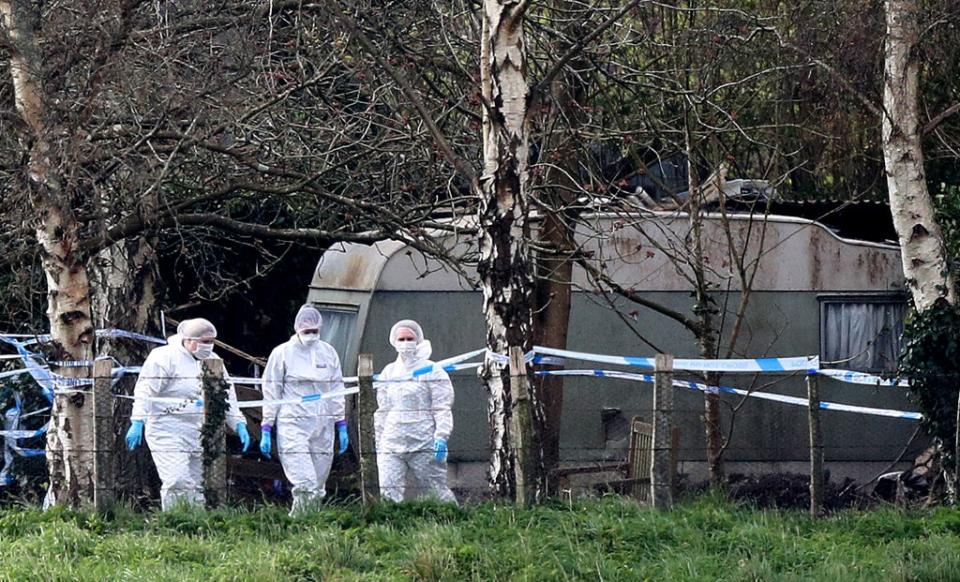 Forensic officers at the scene in Duffield Lane, Woodmancote, West Sussex, where a family of four and their dog were found dead (Andrew Matthews/PA) (PA Archive)