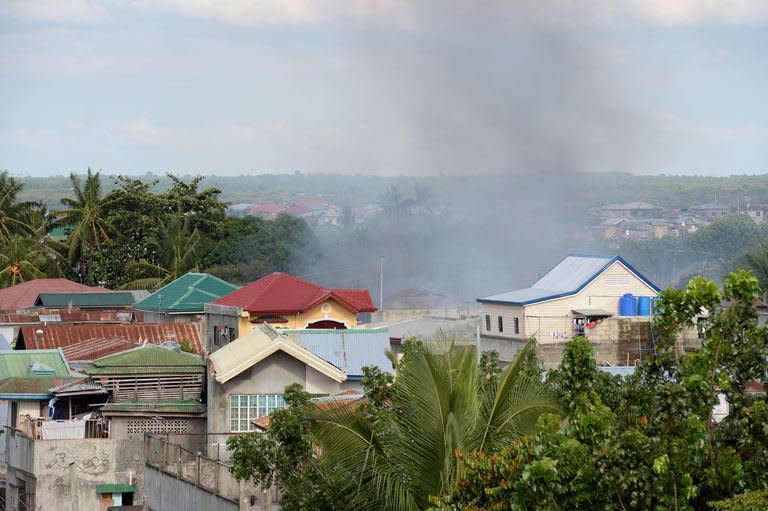 Smoke billows from a burning house during the standoff between Muslim gunmen and army troops in Zamboanga City, on the southern island of Mindanao on September 10, 2013