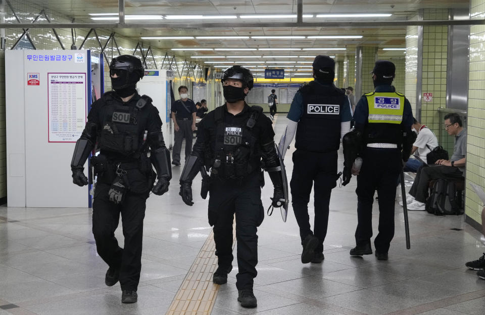 Police officers patrol at Ori subway station following Thursday's attack in Seongnam, South Korea, Friday, Aug. 4, 2023. South Korean police detained a man suspected of stabbing a high school teacher with a knife Friday in the city of Daejeon. The stabbing follows a separate, apparently random attack on Thursday in which 14 people were wounded near a busy subway station in Seongnam. (AP Photo/Ahn Young-joon)