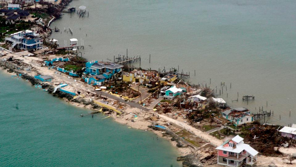 A U.S. Coast Guard aircraft surveys damaged homes and piers in the Bahamas on Sept. 3 after Hurricane Dorian.