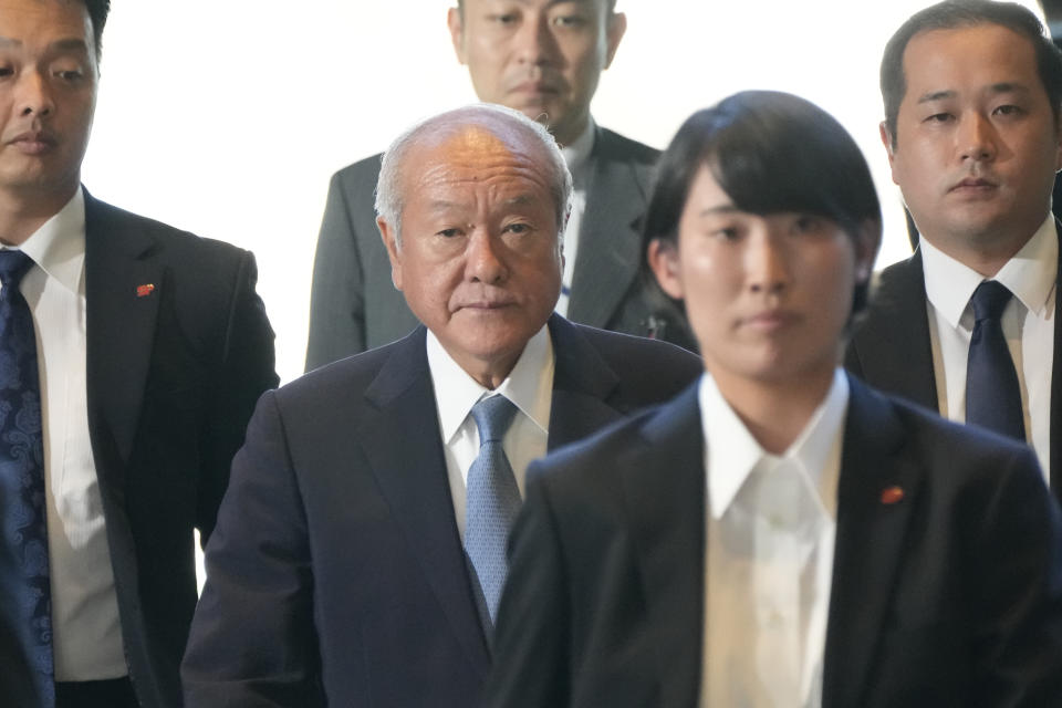 Japanese Finance Minister Shunichi Suzuki, center, arrives at the prime minister's office Wednesday, Sept. 13, 2023, in Tokyo, Japan. Prime Minister Fumio Kishida is shuffling his Cabinet and key party posts Wednesday in an apparent attempt to balance power within the governing party and strengthen his position before a leadership vote next year.(AP Photo/Eugene Hoshiko)