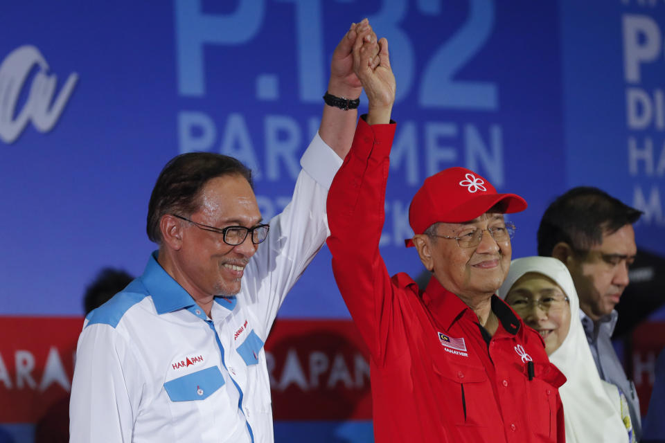 FILE- Then Prime Minister Mahathir Mohamad, right, raises the hand of reform icon Anwar Ibrahim during a rally in Port Dickson, Malaysia on Oct. 8, 2018. Malaysia's king on Thursday, Nov. 24, 2022, named Anwar as the country's prime minister, ending days of uncertainties after divisive general elections produced a hung Parliament. (AP Photo/Vincent Thian, File)