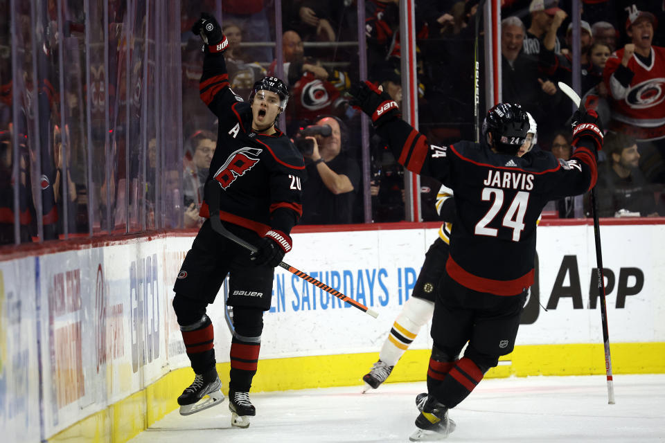 Carolina Hurricanes' Sebastian Aho (20) celebrates with teammate Seth Jarvis (24) after scoring during the first period of an NHL hockey game against the Boston Bruins in Raleigh, N.C., Sunday, Jan. 29, 2023. (AP Photo/Karl B DeBlaker)