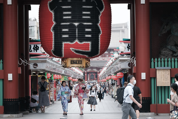 Visitors walk past a giant lantern at the entrance to the Sensoji temple in the Asakusa district of Tokyo, Japan.