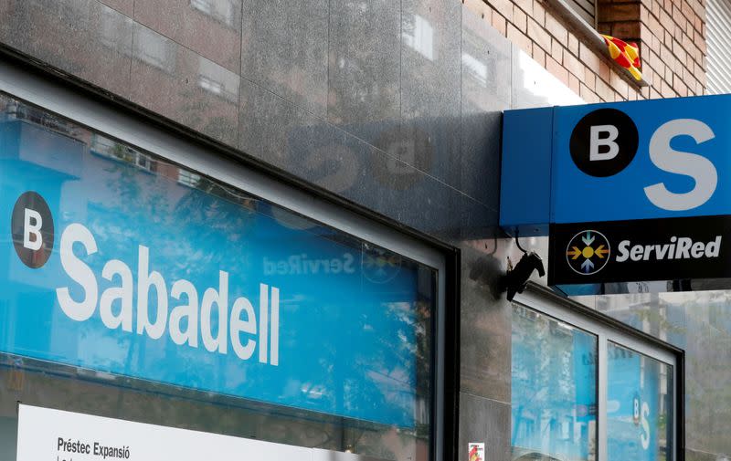 FILE PHOTO: FILE PHOTO: A Catalan flag is seen above a logo at the Sabadell bank branch in Barcelona