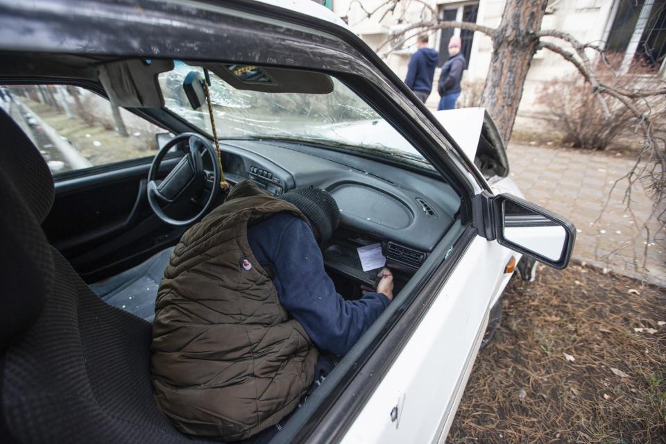 FILE - The body of a victim is seen in a damaged car in Almaty, Kazakhstan, Friday, Jan. 7, 2022. The government, by then led by Nazarbayev's close ally Tokayev, responded with a deadly clampdown, culminating in a "shoot-to-kill" order as the president blamed "terrorists" allegedly funded and trained from abroad. (AP Photo/Vasily Krestyaninov, File)